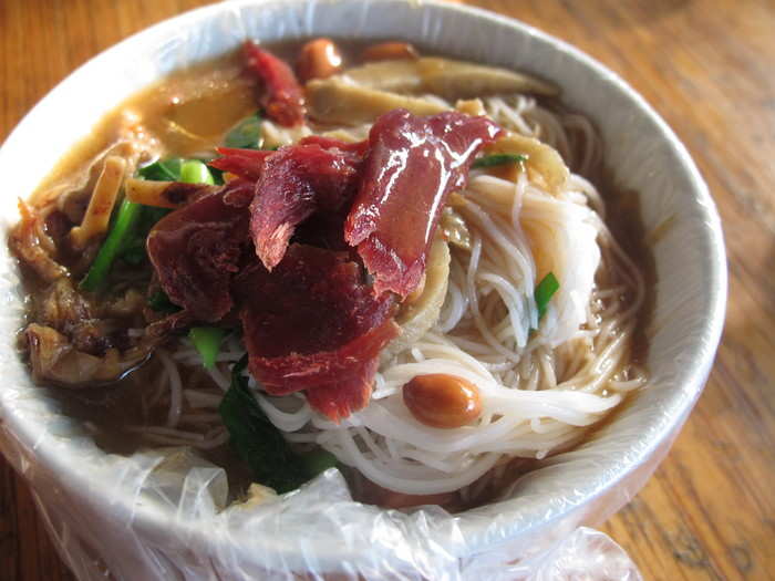 Noodle dishes, like this Ling Shui Suan Fen, are common in China. This one has an intense savory broth, noodles, and dried cuttlefish with a sour plum sauce.