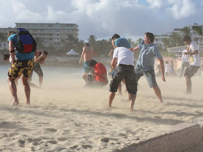 Because the runway is so close to the beach, planes taking off blast tourists with their powerful jet engines.