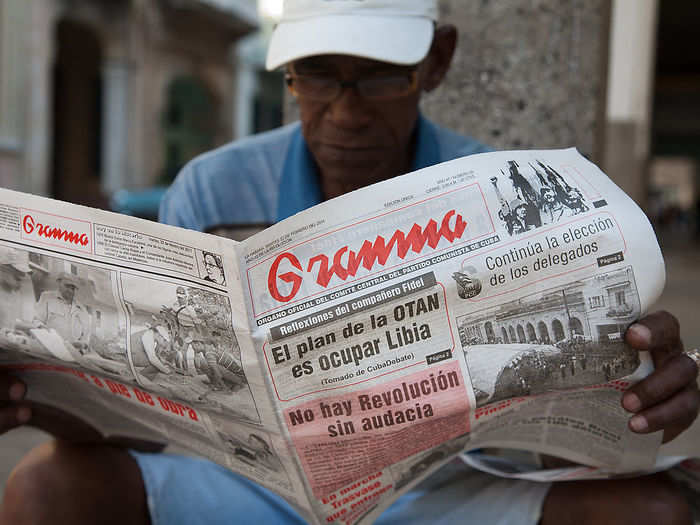 When Castro and Guevarra marched into Cuba in 1959, the communist revolution turned the country upside down. Here a man reads 