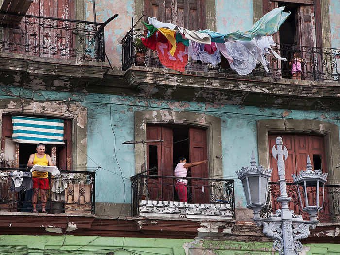 The Capitolio is surrounded by a mix of residential and non-residential buildings. These crumbling apartments where Habaneros hang laundry stand opposite the Capitolio.