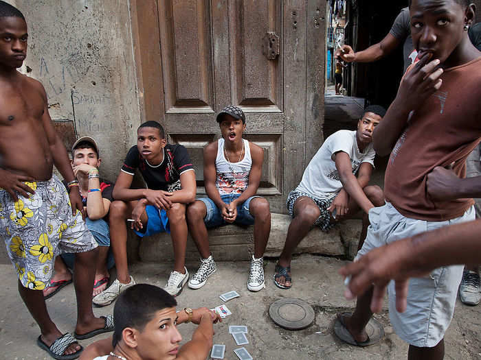 Teenagers play cards.