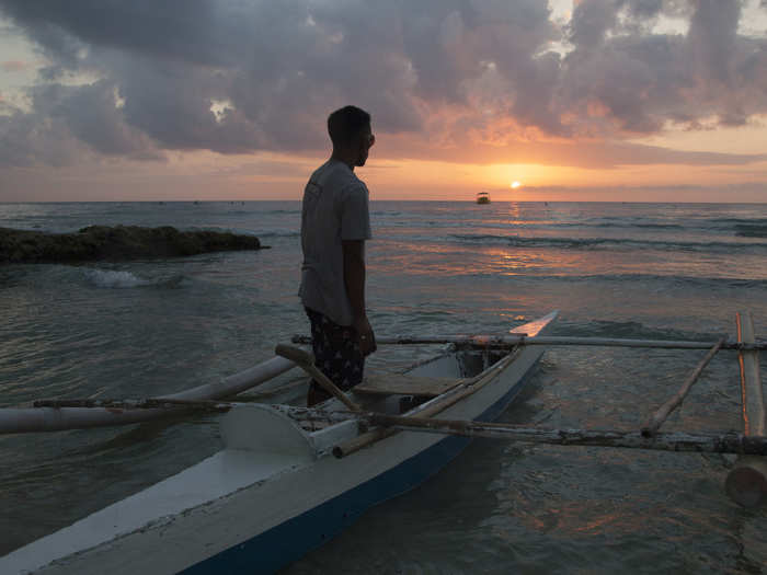 Fishermen get up at dawn to search for and feed whale sharks off the beach.