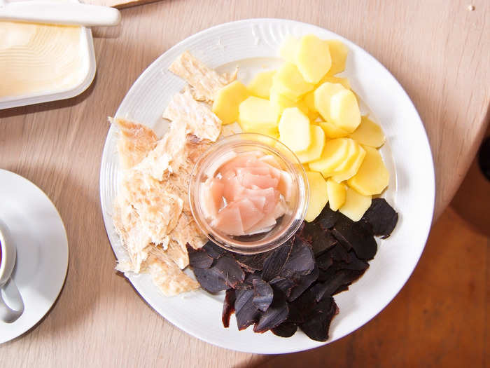 Whale meat can be prepared many different ways. Some may preserve it in salt to save for the winter. Others may cut it into strips and hang is outside to dry for a few weeks. Here is a traditional meal in which the dried meat (black) has been boiled and served with blubber (middle) and potatoes.