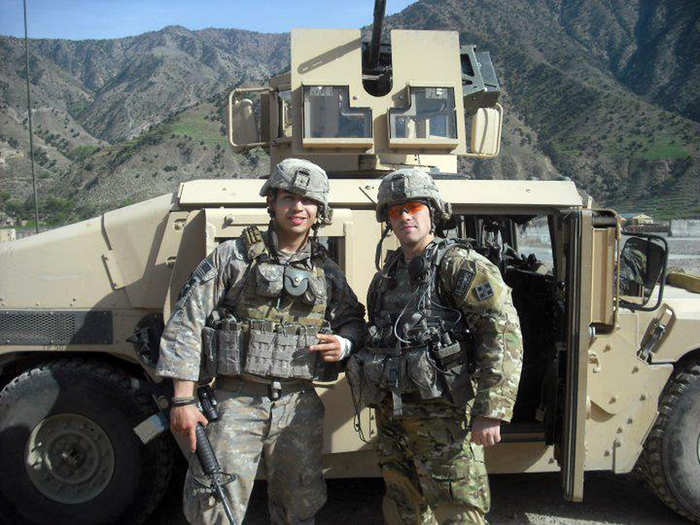 Daniel Rodriguez and Clinton Romesha stand in front of a Humvee with a .50 caliber machine gun. These heavy gun trucks became huge targets on Oct. 3 as Taliban fighters continued to fire at anyone defending the base from the gun turrets.