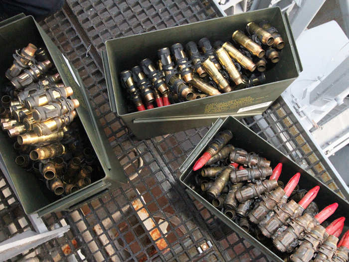 The belts of rounds are separated off and placed in ammunition cans.