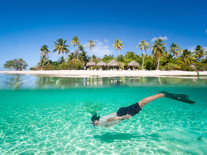 Matira Beach in Bora Bora, French Polynesia, has sparkling turquoise water, white sand beaches, and romantic over-water bungalows where you can really enjoy it all.