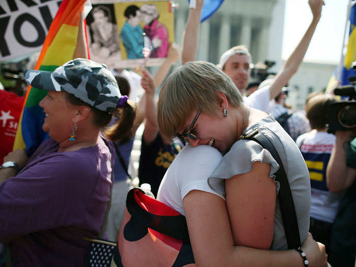 Sharon Burk and Mollie Wagoner, students at American University, embrace upon hearing that DOMA was ruled unconstitutional.