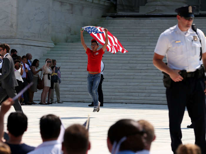 A man with an American flag sprinted down the courthouse steps in honor of DOMA being overturned.