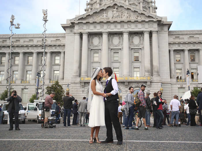 Lisa Dazols and Jenny Chang celebrate outside the city hall in San Francisco.