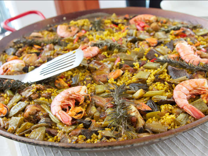 Share a pot of paella, saffron-infused rice with seafood and chorizo, with friends at famed Can Majó, a restaurant on the beach in Barcelona.