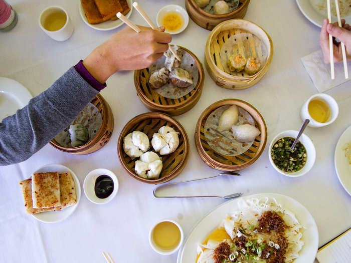 Sample dozens of bite-sized morsels—dumplings, pork buns, turnip cakes, noodles—at dim sum in Hong Kong.