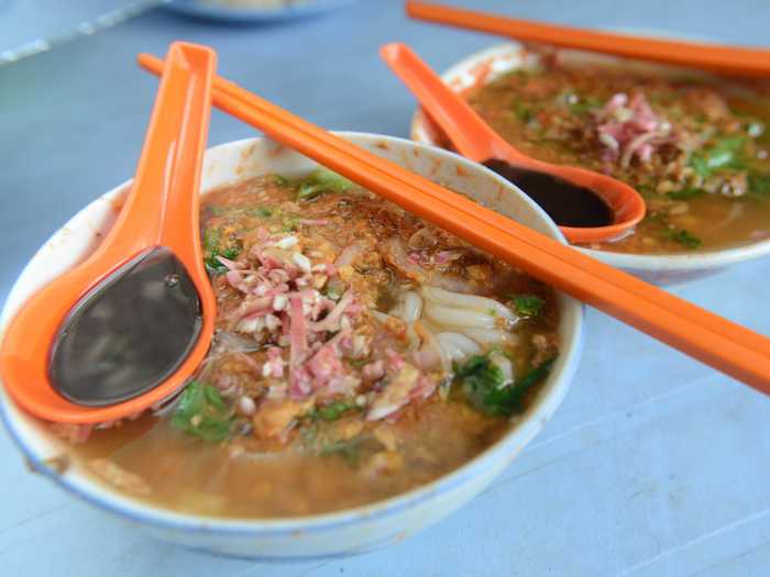 Lap up a bowl of asam laksa, a spicy and sour fish-based noodle soup, in Penang, Malaysia.