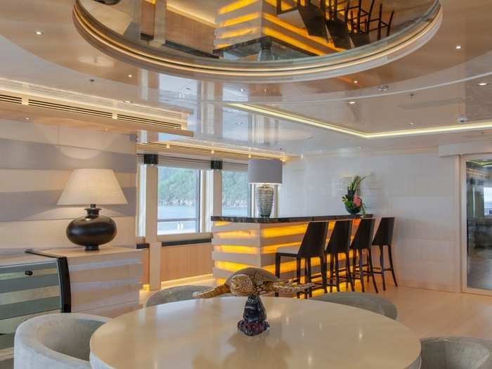 A full bar with accompanying seating area features a mirrored ceiling and is perfect for those chilly nights on the open sea.