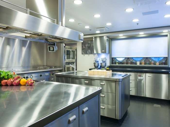 The enormous kitchen is fully-staffed and outfitted with stainless steel appliances, countertops, and cabinets.