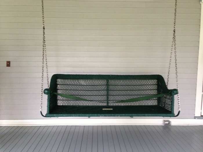 An original swinging bench remains on the porch.