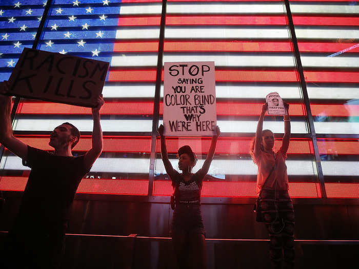 Protesters gathered in front of an electric American flag in Times Square to express their dissatisfaction with the Florida court