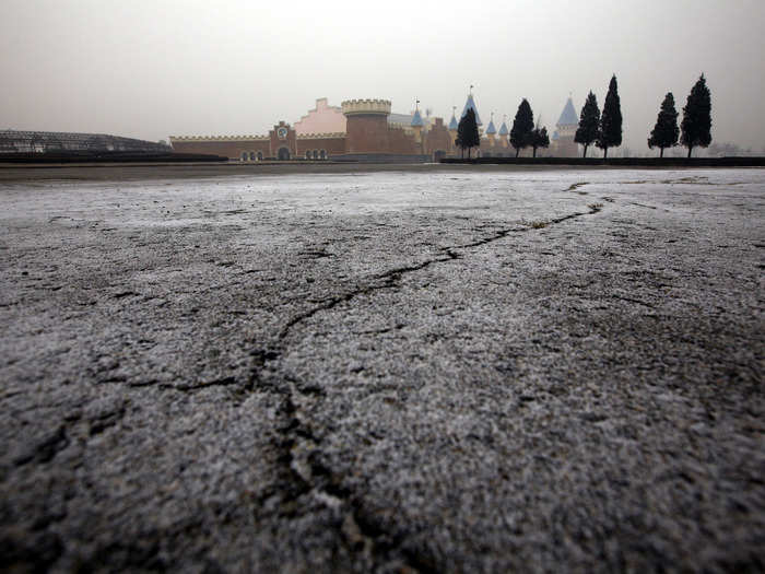 Cracks are visible in the car-park.