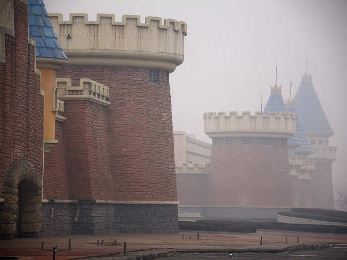 The empty amusement park seems even more eerie shrouded in smog.