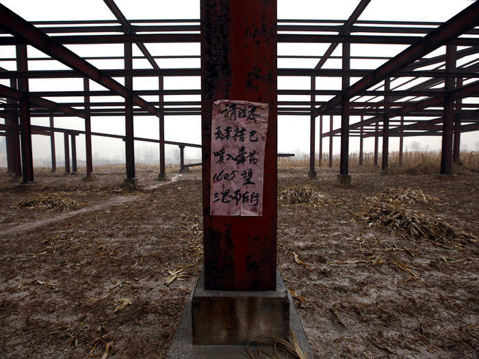 A sign warns locals about possible poisons in the soil.