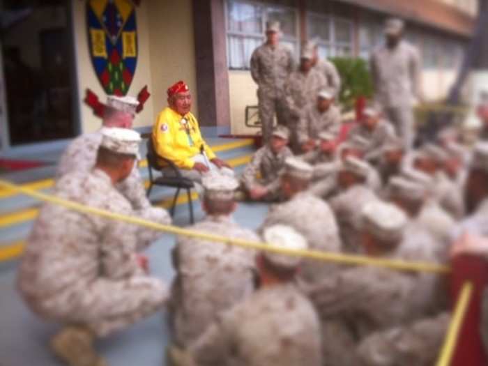 Here a group of young Devil Dogs listen to one of the few remaining World War II Native American code talkers.