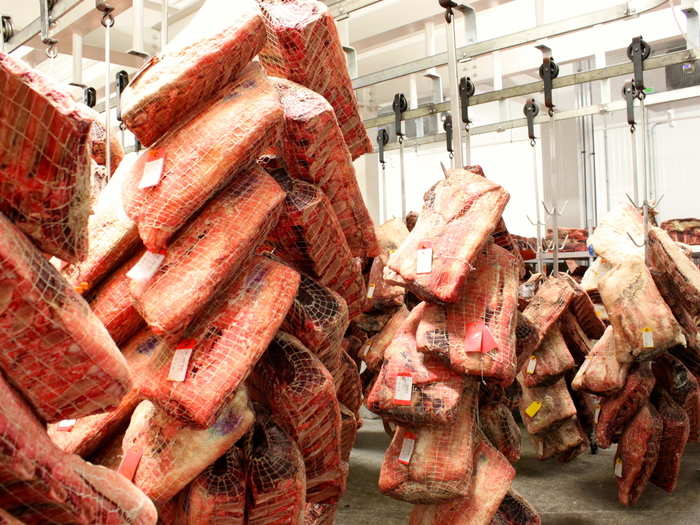 The dry-aging rooms smell woody, clean and delicious. Cuts of meat that arrive are quickly sliced, labeled by date, and sent to one of the enormous dry-aging rooms to hang for predetermined periods of time.