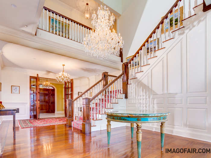 The main staircase adds to the drama and splendor of the entranceway.