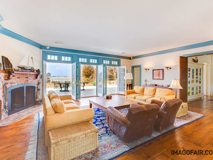 The ocean is visible at all times through floor-to-ceiling windows, as seen in the luxe living room.