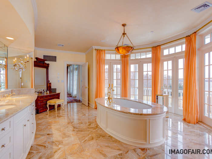 The main house alone has 9 bathrooms. This one includes a double vanity and a dramatic bathtub with smooth marble finishes.