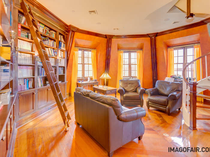 The library is also full of natural light and dark touches complement the rich wood paneling. Bonus: it has a ladder that slides slide across the entire bookcase.