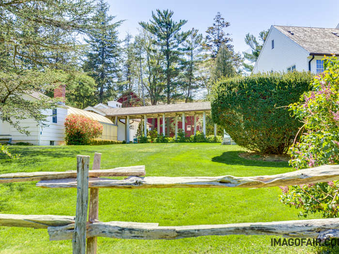 A covered walkway connects the main house with a greenhouse and accompanying 3,000-square-foot historic guesthouse that has 4 bedrooms and was originally constructed in 1860.