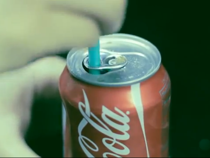 To keep a straw inside a can of soda, turn the tab around and insert the straw.