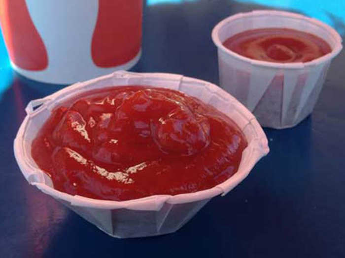 Pull apart ketchup cups, which are expandable, to fit more of the condiment.