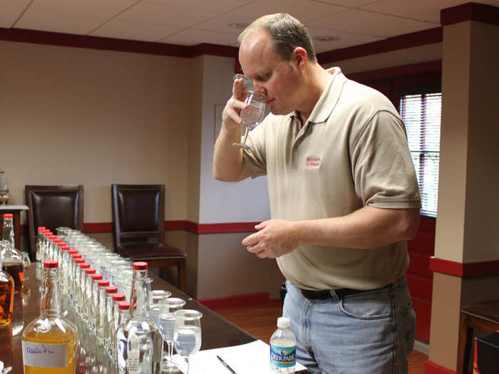 Tasters sniff the "white dog," then swirl it and sip it to make sure there