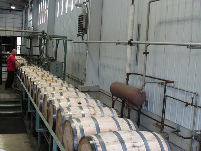 The "bung" of each barrel is hammered in by hand. Once barrels are filled, they are sent to a warehouse, where they