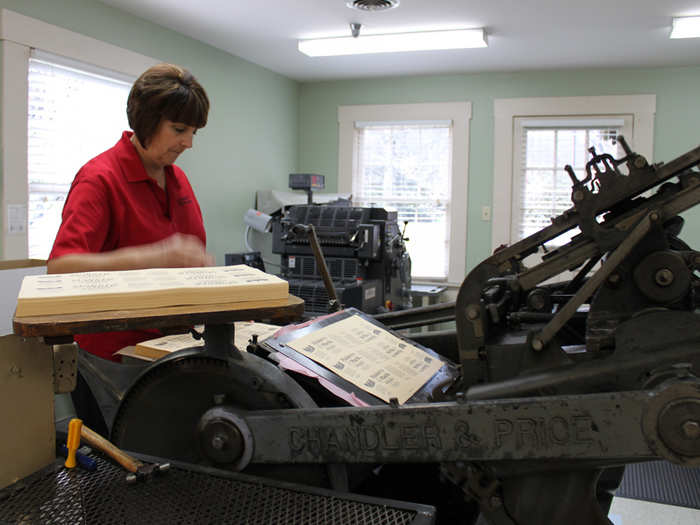 And a hand-operated cutting machine is used to stamp out labels.