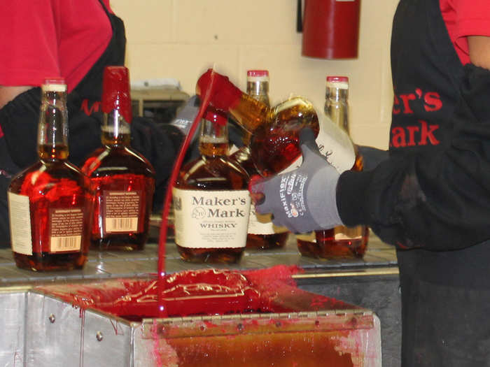 If the wax drips onto the label, the bottle is rejected. The red wax seal is trademarked.