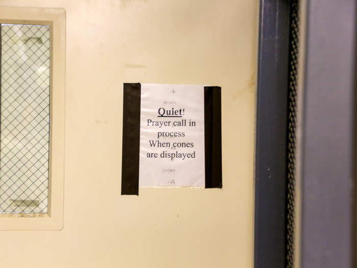 A sign on the door reminds staff to respect prayer times.