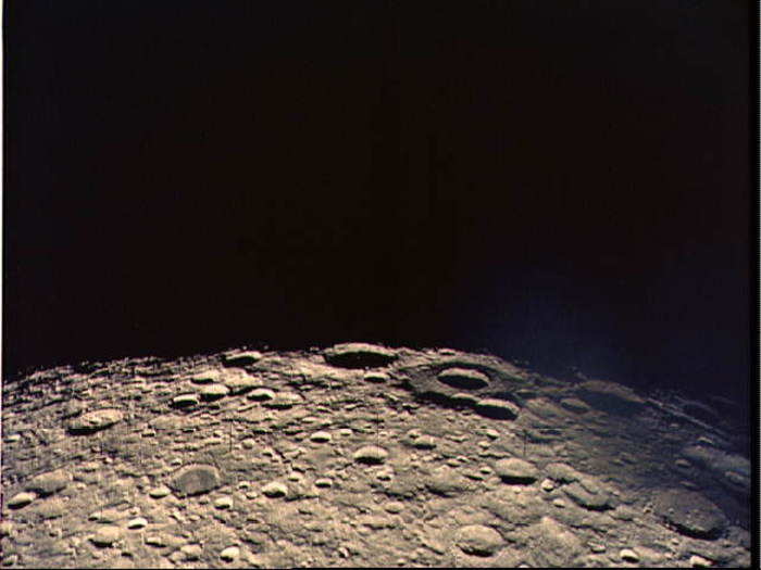 The crew photographs the far side of the moon from the Apollo 13 spacecraft on their perilous journey home.