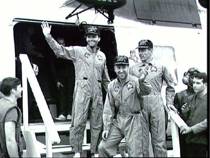 Haise, Lovell, and Swigert step off a helicopter onto recovery ship U.S.S. Iwo Jima.