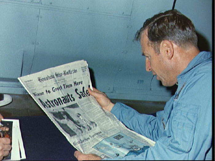 A day later, Lovell reads the newspaper account of Apollo 13