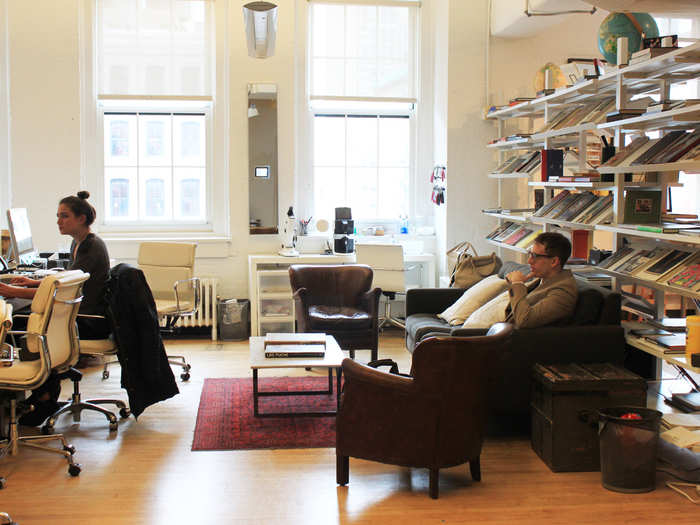 On the other side of the book shelf was an open waiting area with leather couches and tables for guests.