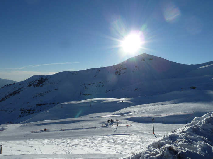 As the sun began to set, the trails, etched with lines from skiers and snowboarders, glistened in the harsh light.