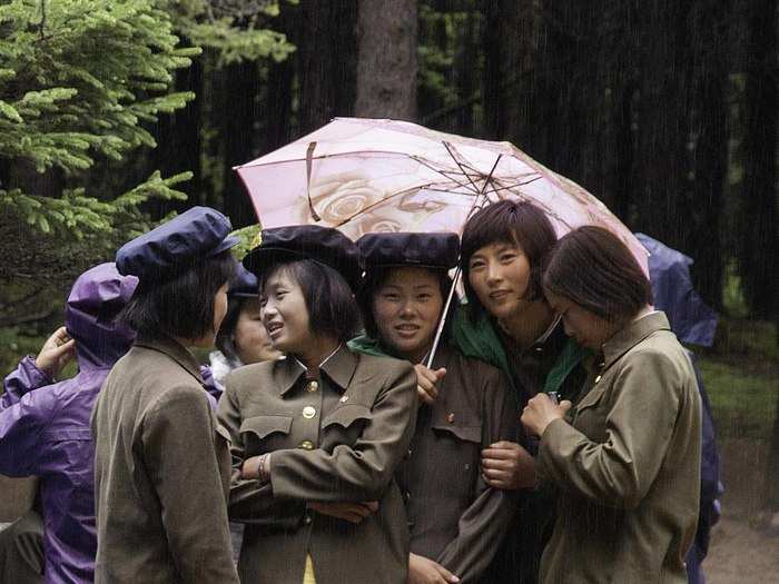 Young cadets of the Korean People’s Army take shelter under an umbrella in the famous larch pine forests of the Paektu-gowon plateau.