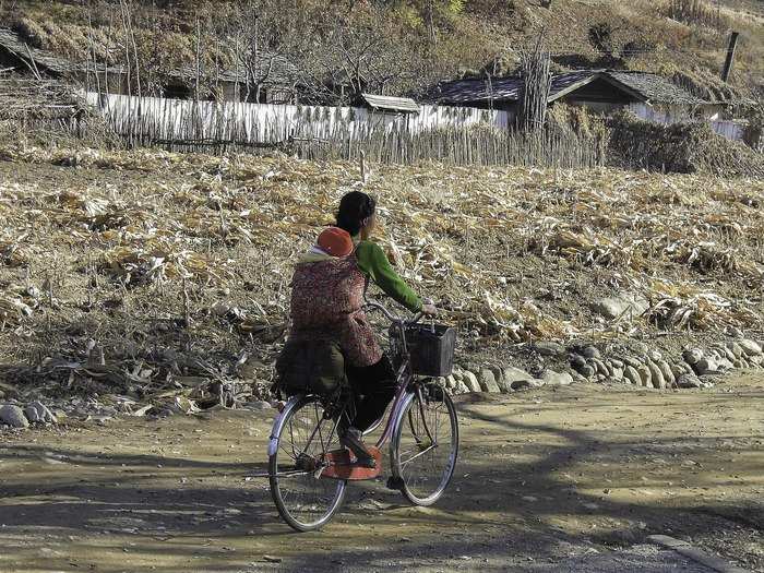 The squeaky spokes of the bicycle of a young mother and baby were the only sounds I heard as I sat on the side of the road in the tranquil silence of the North Korean countryside. As a New Zealander, the sound of silence is like medicine to me.