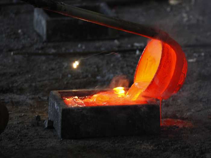 He then pours the liquid Lanthanum into a mold.