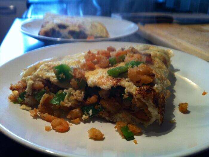 161 calories: A FastDiet prawn omelet breakfast includes 1.5 eggs, 1/4 can of prawns, and spring onions.