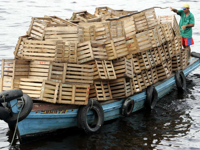 A riverboat in Amazonas, Brazil is overloaded with empty boxes.