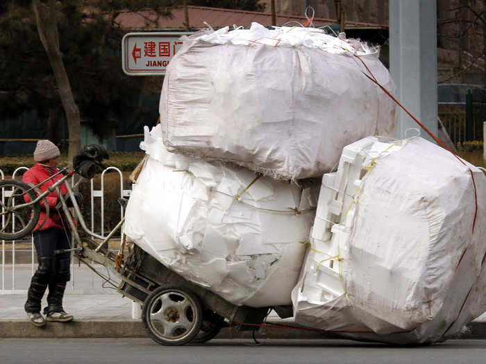 In Beijing, a woman loaded her tricycle with recyclable materials.