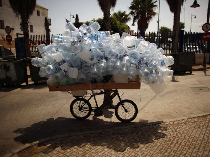 A woman sells empty water bottles to people traveling between Spain and Morocco.