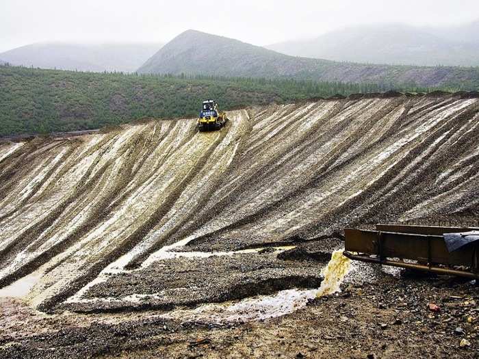 The lighter ore and water are then deposited in mounds.